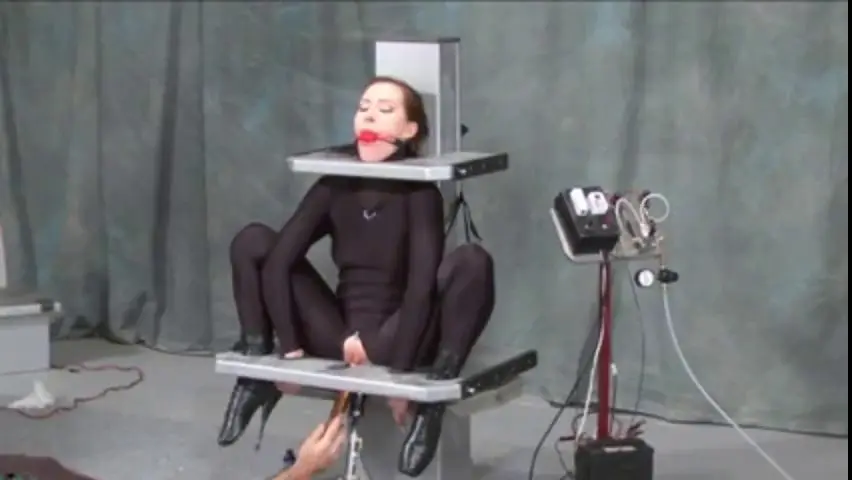 submissive girl enjoys bondage and bdsm treatment on a machine poster