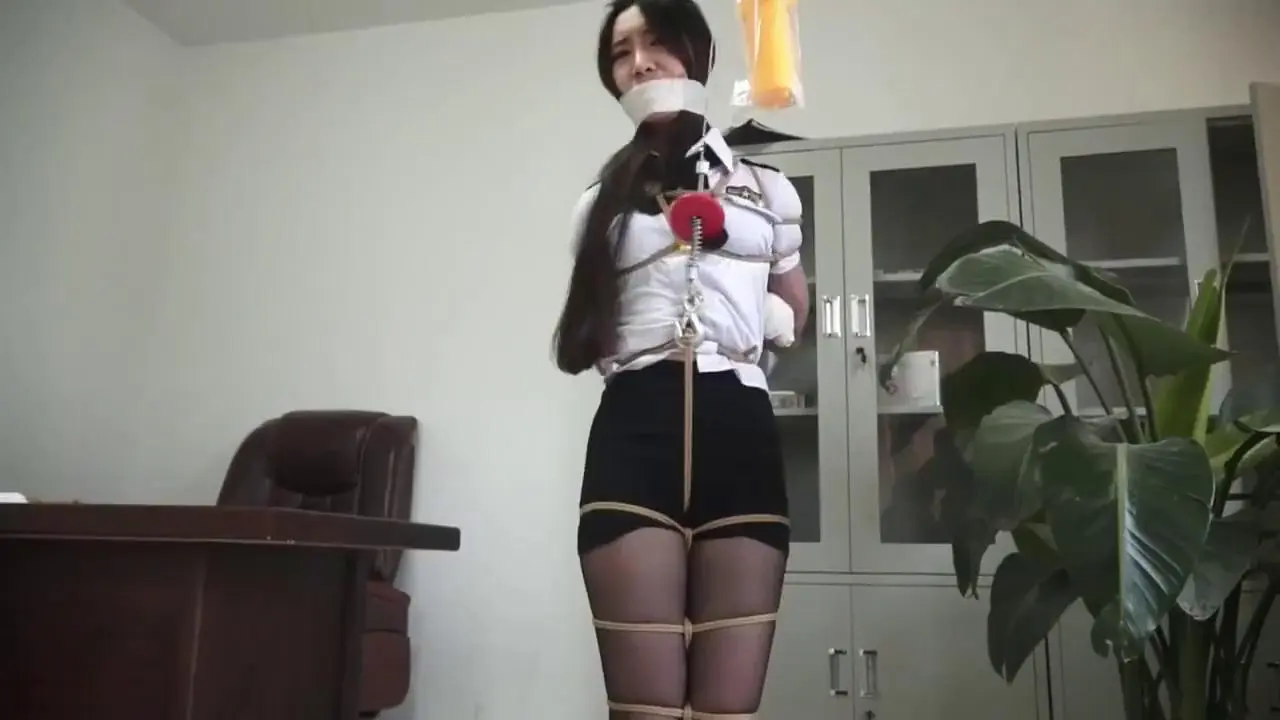 asian chick is tied up completely and forced to struggle poster