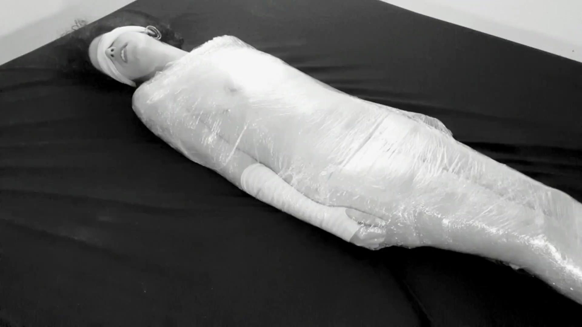 mummified in plastic wrap girl gets fucked and squirts after fingering poster